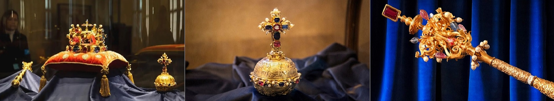 Three ceremonial royal regalia on display: a jeweled crown on a red cushion, a gold cross reliquary centerpiece, and a gem-studded scepter against blue fabric edges.