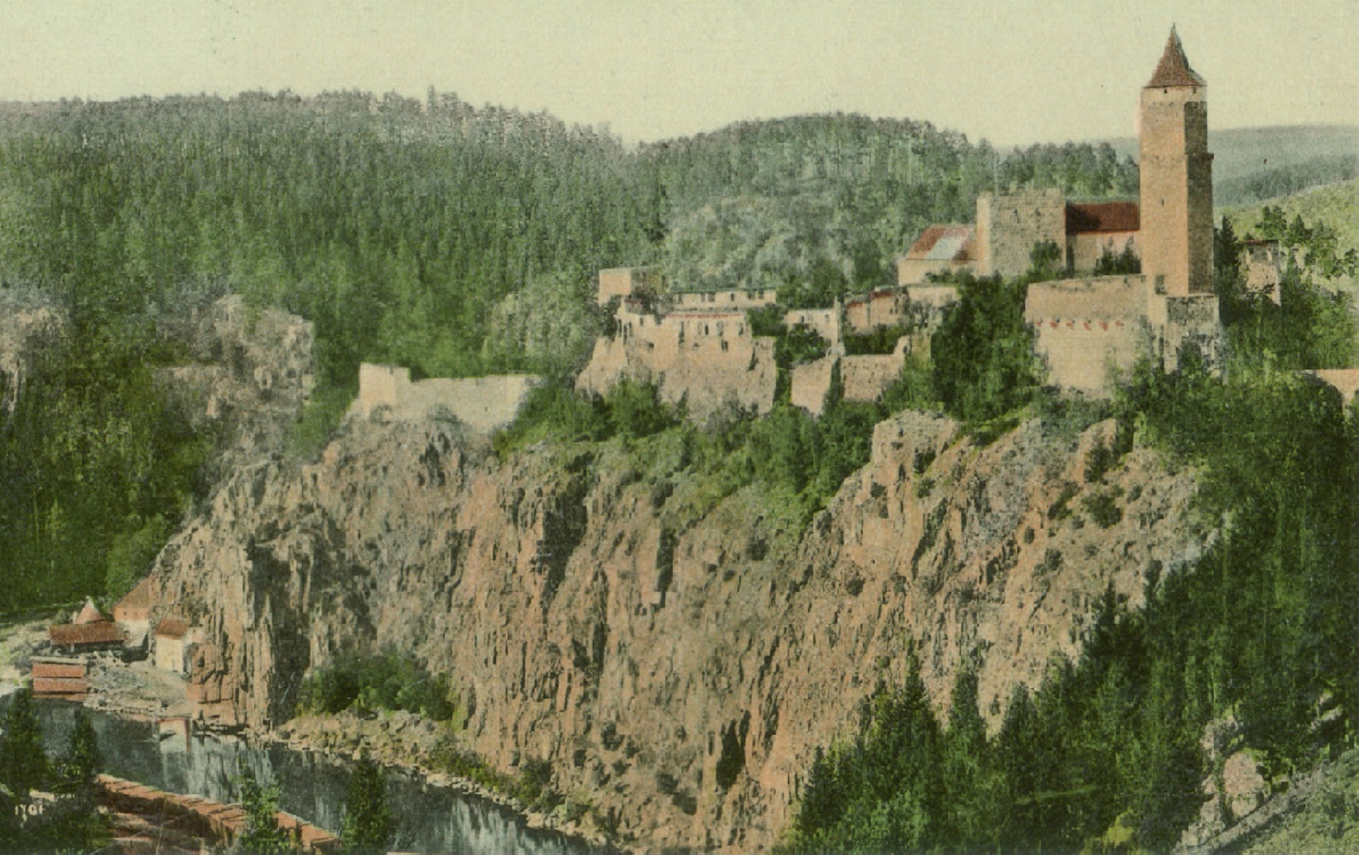 Stone fortress with a tall square tower perched on a rocky cliff above a forested hillside.